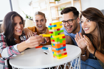 Happy group of friends have fun and playing board game together
