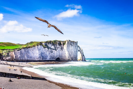 Etretat Aval cliff, rocks and natural arch landmark and blue ocean. Normandy, France, Europe. Beatiful summer panorama.
