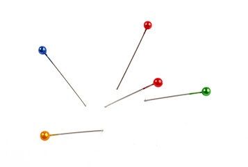 five multi-colored pins on a white background, isolate.
