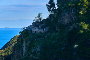 Aramai farmhouse abandoned and in ruins built on a spur of rock overlooking the sea in the municipality of Savoca, Island of Sicily