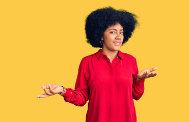 Young african american girl wearing casual clothes clueless and confused with open arms, no idea...