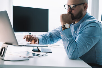 Serious businessman working on laptop in office