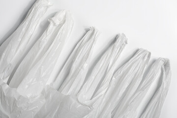 white plastic bag on white background. A White Plastic Bag Texture, macro, background. Reduction of plastic bags for natural treatment. The symbol of the campaign to refrain from using plastic bags.