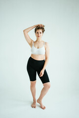 Fototapeta premium Natural pretty curvy model woman wearing underwear in white photo studio