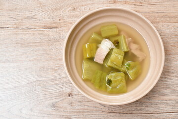 boiled bitter cucumber with slice pork belly in clear soup on bowl
