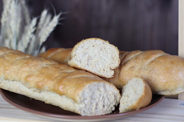 fresh baked bread of white wheat powder on wooden background