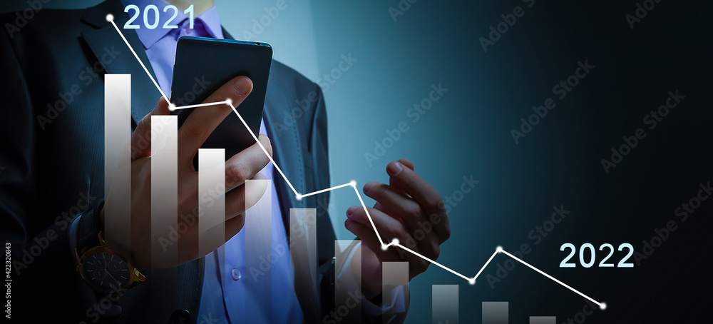 Poster businessman's hand holds a stock graph display in a visual screen. it shows signs of falling stocks 