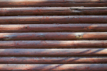 Close-up colorful picture of wooden brown wall for background. Part of old house in Russia....