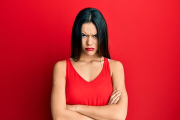 Young hispanic girl wearing casual style with sleeveless shirt skeptic and nervous, disapproving...