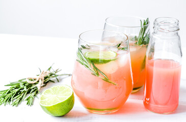 healthy morning with fresh drink, lime and rosemary on white table background