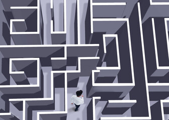 Businessman trying to find way out of maze, above view