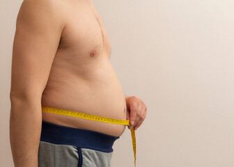 man measuring his waist. obesity concept