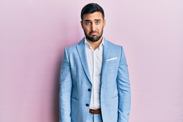 Obraz premium Young hispanic businessman wearing business jacket depressed and worry for distress, crying angry and afraid. sad expression.