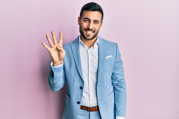 Young hispanic businessman wearing business jacket showing and pointing up with fingers number four...