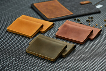 Set of handmade leather goods, key holder rings, wallet, purse, notepad, handbook. Handcrafted leather goods, close-up