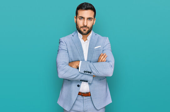 Young hispanic man wearing business jacket skeptic and nervous, disapproving expression on face with crossed arms. negative person.