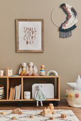 Stylish scandinavian newborn baby room with brown wooden mock up poster frame, toys, plush animal and child accessories. Cozy decoration and hanging cotton flags on the beige wall. Template.