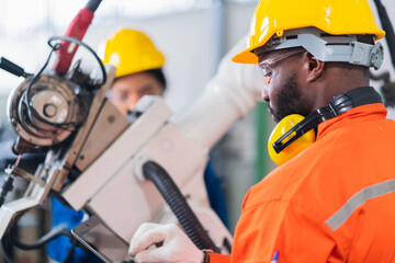 engineer cooperation male and female technician maintenance control relay robot arm system welding...