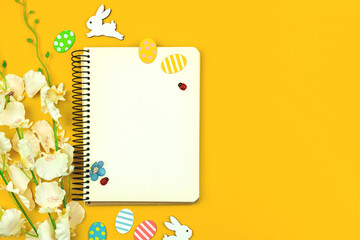 Spring mockup with easter decor on a yellow background, top view and copy space