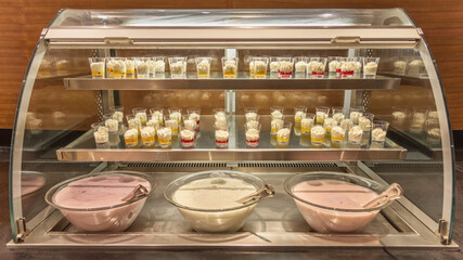 Hotels Breakfast Buffet. The regional cuisine of Israel in a hotel. Different types of fresh yogurts and desserts. Buffet etiquette