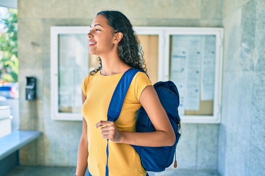 Young african american student girl smiling happy walking at university campus.