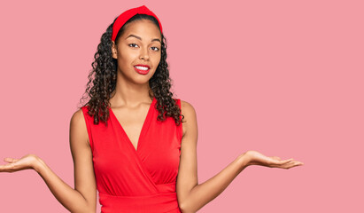 Young african american girl wearing elegant and sexy look clueless and confused expression with...