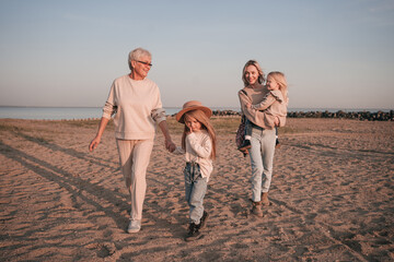 Happy family of mother with daughters and grandmother together in nature