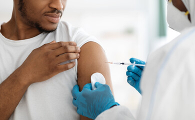 Cropped of black man receiving vaccine shot - obrazy, fototapety, plakaty