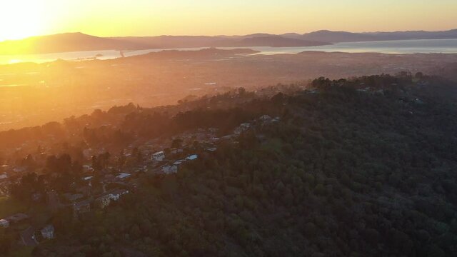 The last light of day illuminates the hills overlooking San Francisco Bay. This famous body of water is bordered by San Francisco, Oakland, Berkeley, Sausalito, and Marin among other cities.