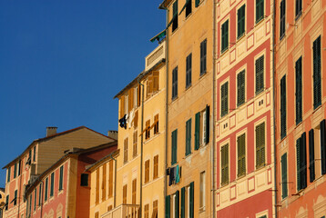 Fototapeta na wymiar Camogli is a marine village of Liguria with tall, brightly colored Mediterranean houses.