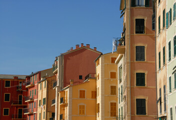 Fototapeta na wymiar Camogli is a marine village of Liguria with tall, brightly colored Mediterranean houses.