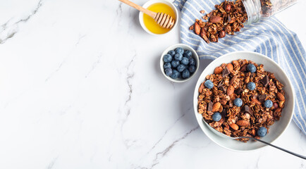 Homemade granola, muesli with pieces of dark chocolate, nuts and blueberries