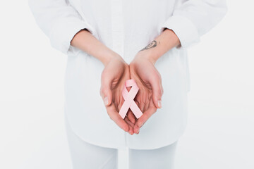 Cropped view of woman holding ribbon of breast cancer awareness isolated on white