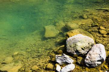The stones under the pond, close-up as a background.