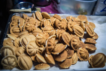 
Traditional snacks baked in a wood-fired oven for sale in Naklua Walking Street Market, Pattaya