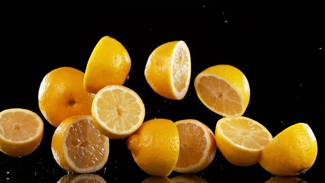 Super slow motion of falling lemon slices
