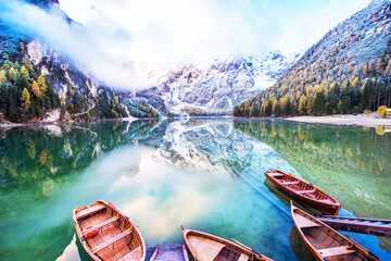 Magical beautiful fairy autumn landscape with boats on the lake on Fanes-Sennes-Braies natural park...
