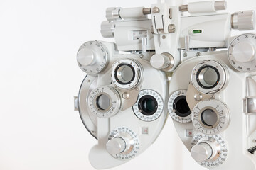 Selective focus at Optometry frame equipment. With blurred white background for copy space. Optometrist tool to examine eye visual system of patient with professional machine before made glasses.