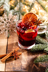 Christmas mulled wine with spices on a wooden rustic table.