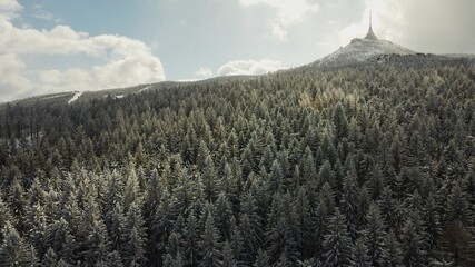 Winter drone photo of Ještěd.
Snow covered trees.