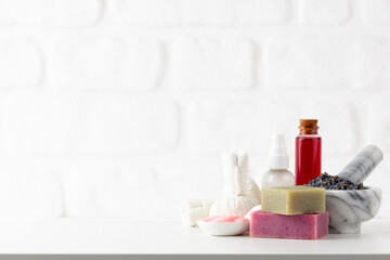Obraz na płótnie Canvas Cosmetics bottles and natural handmade soap on white background