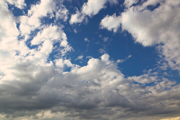 dramatic blue sky with rays and white clouds
