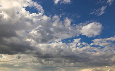 Fototapeta na wymiar dramatic blue sky with rays and white clouds