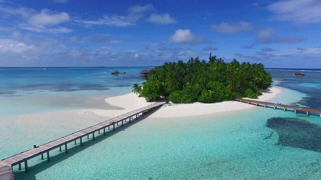 Aerial view of tropical island with coco palm trees, white sand and turquoise crystal clear water. Paradise island in Maldives.