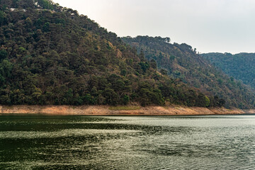 lake calm water with mountain background at day from flat angle