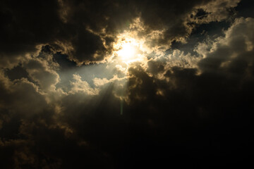sun rays through cloud patch at day dramatic scene