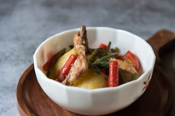 Close up of chicken stew with vegetables in a bowl with use of selective focus.