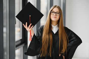 Woman portrait on her graduation day. University. Education, graduation and people concept.