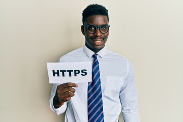 Handsome black man holding https privacy url looking positive and happy standing and smiling with a...