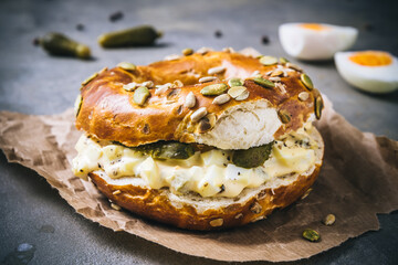 Bagel bun sandwich with egg salat on gray background
